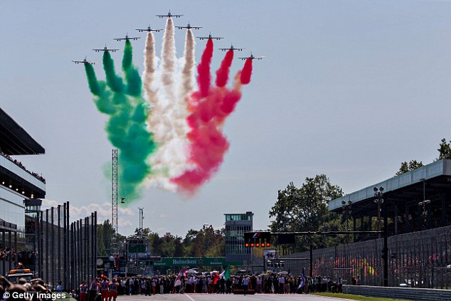 The Italian air force perform a flyby at Monza with green, white, and red smoke.