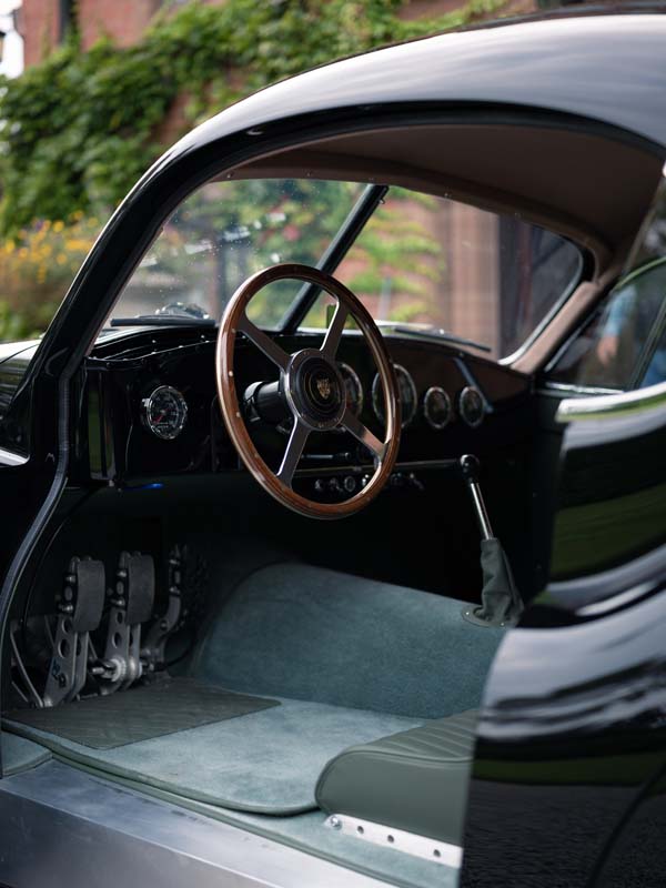 Interior shot of the XK120 LM showing its large wooden steering wheel.