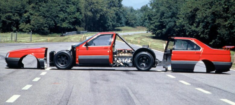 The Alfa Romeo 164 Procar viewed from the side with the front and rear clips removed to reveal its mid-mounted Formula 1 V10 engine.|The Alfa Romeo 164 Procar viewed from the side with the front and rear clips removed to reveal its mid-mounted Formula 1 V10 engine.|Alfa Romeo 164 Procar|Side view of the Alfa Romeo 164 Procar's 3.5 litre V10 engine.|Source: Giphy