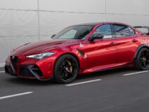Alfa Romeo's new lightweight Giulia GTAm in red.|Alfa's new Giulia GTAm looking like a very angry owl.|||Side profile of the Giulia GTAm showing off its wider carbon fenders.|Rear view of the Giulia GTAm showing the new rear wing and diffuser.|Badging on the back of the Giulia GTAm.