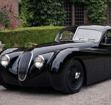 The Jaguar XK120 LM sits outside Sir William Lyons' country house.|Side view of the black-on-black XK120 LM showing off its sleek