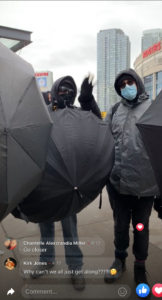 Former (?) Proud Boy Josh Chernofsky standing outside the Rec Room, holding an umbrella